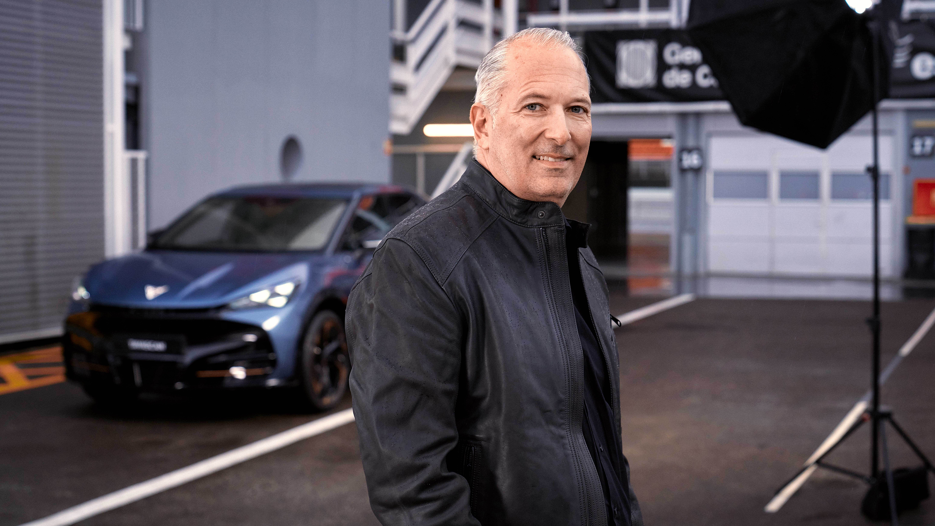 Cupra CEO Markus Haupt standing next to a car