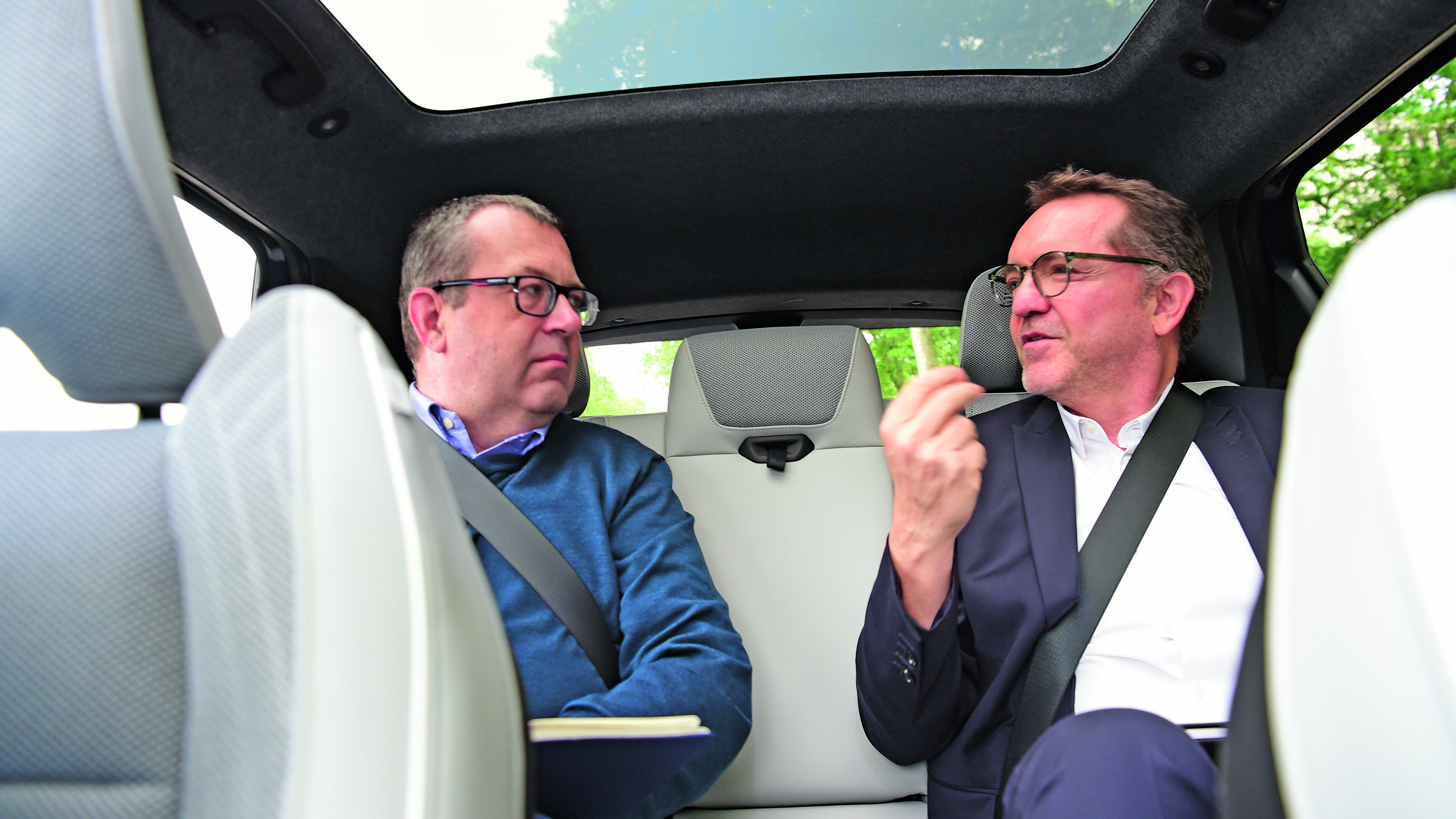 Out-going Renault UK boss Guillaume Sicard and John McIlroy talking in the back of a Renault Scenic