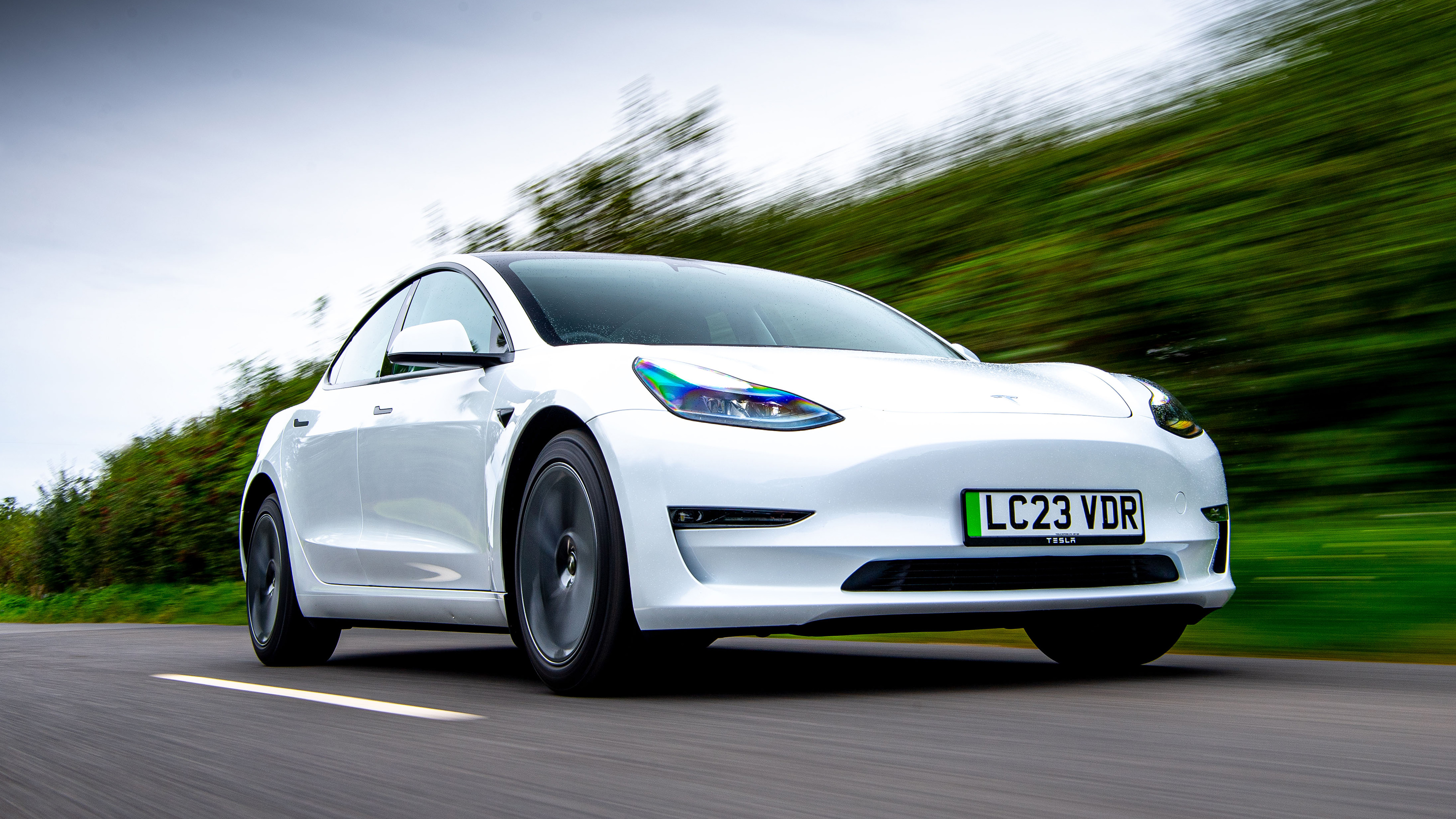 Tesla Model 3 driving down the road