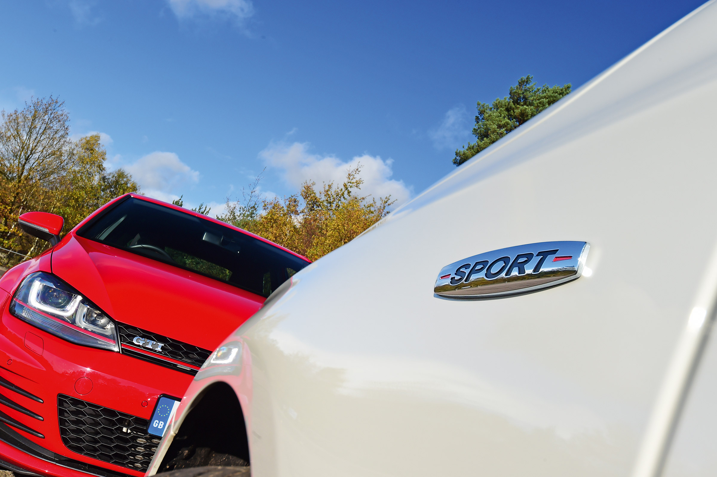 Mercedes A 250 AMG vs Volkswagen Golf GTI - badges