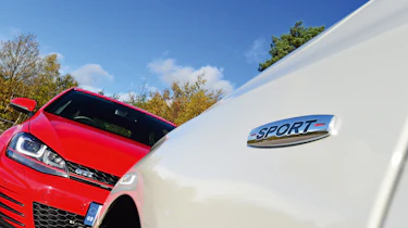 Mercedes A 250 AMG vs Volkswagen Golf GTI - badges