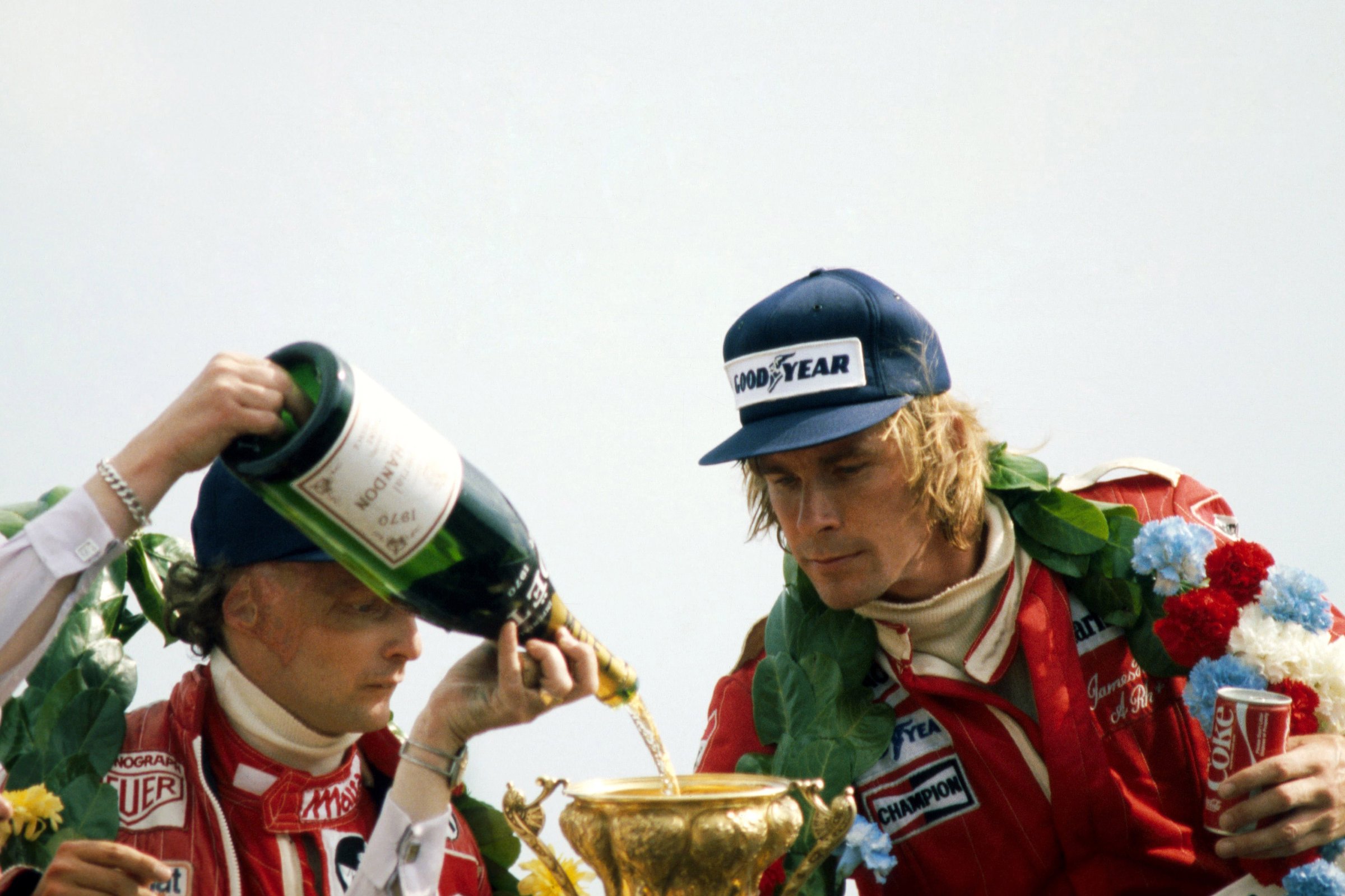 Second-place Niki Lauda and winner James Hunt on the podium at the 1977 British Grand Prix