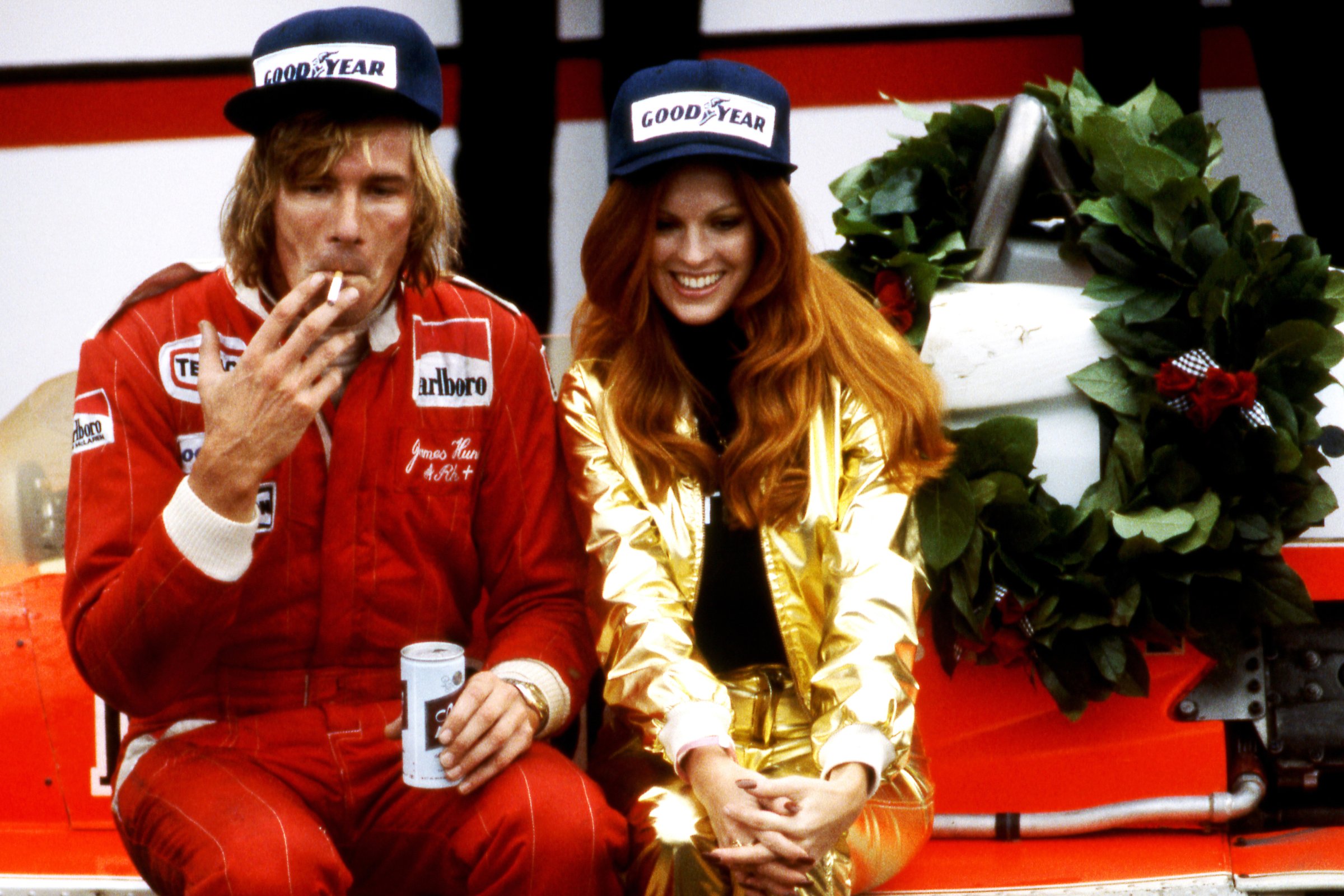 James Hunt celebrates winning the 1977 US Grand Prix win with a cigarette, a beer, and a Penthouse Pet