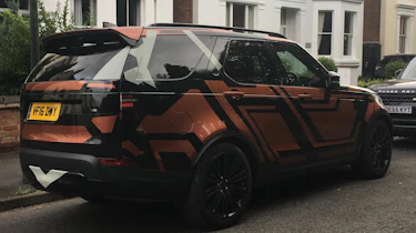 Land Rover Discovery 2017 - spy shot orange rear quarter