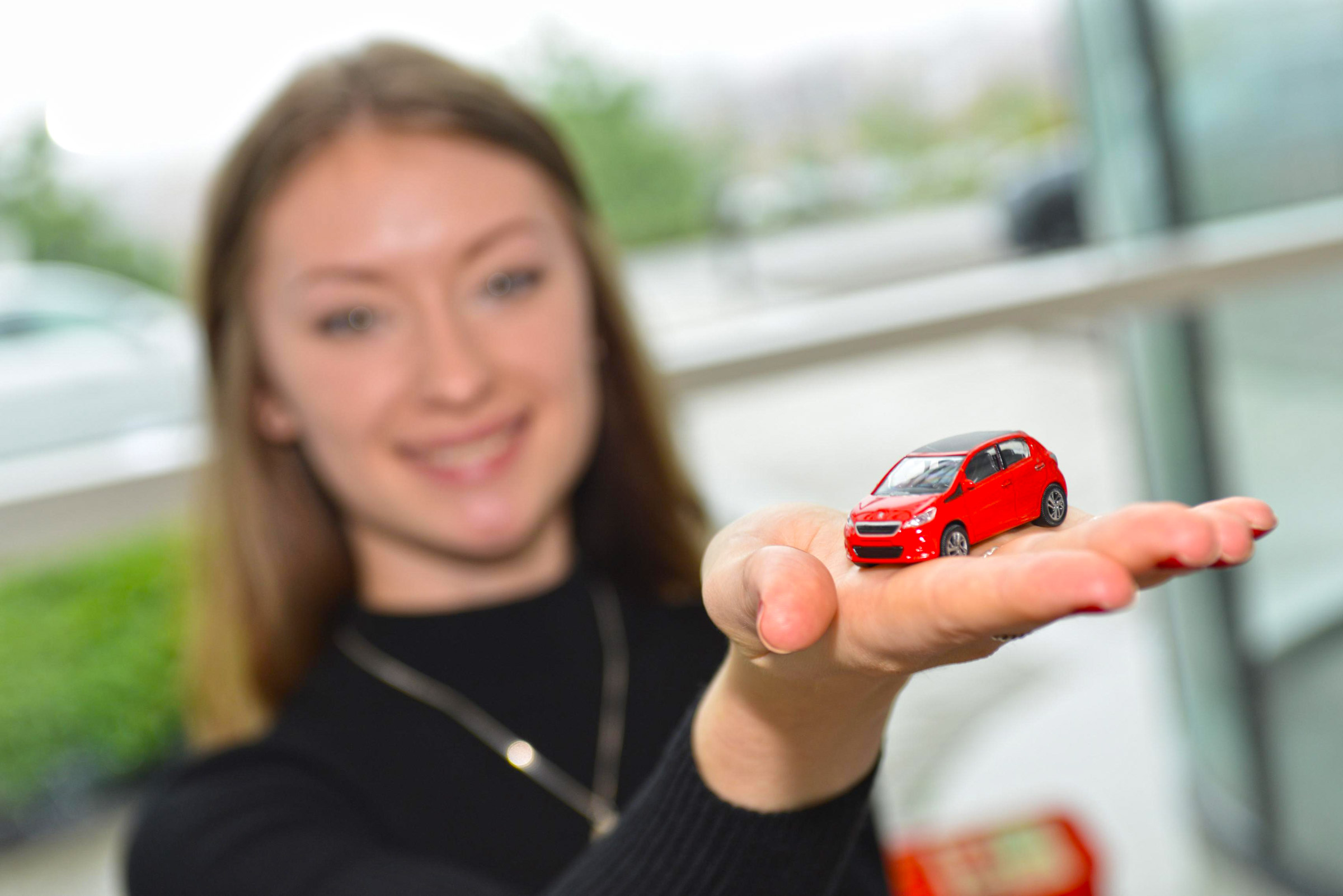 lady holding toy car