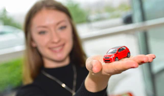 lady holding toy car