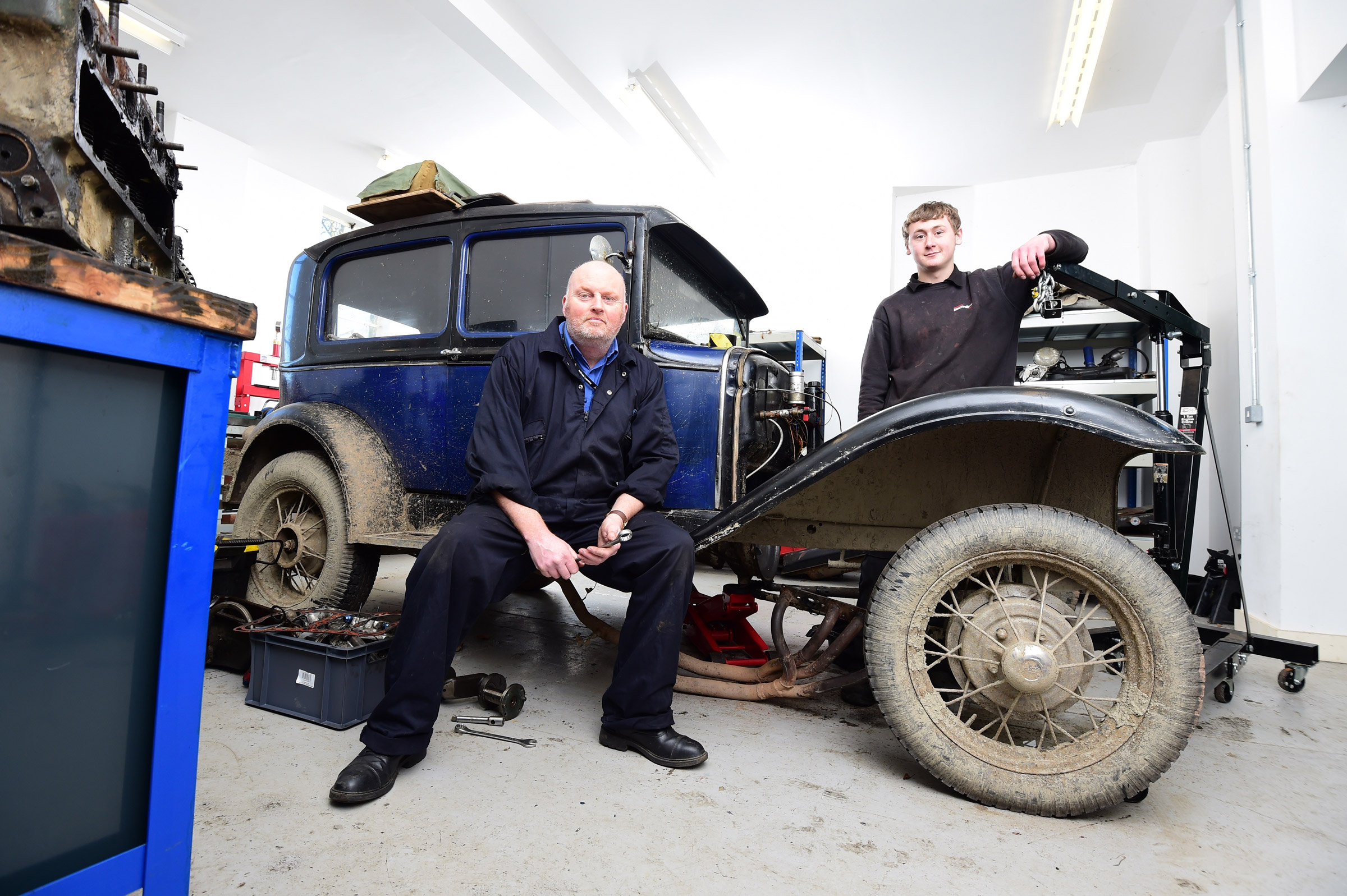 Teacher and student with classic car