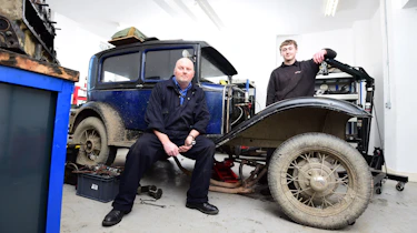 Teacher and student with classic car