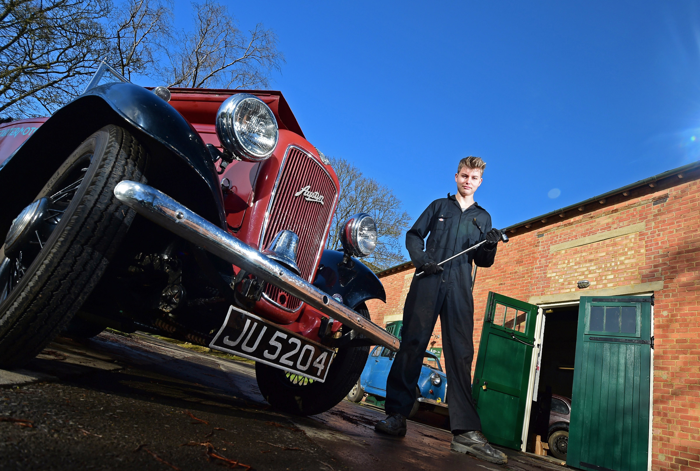 Student next to classic car