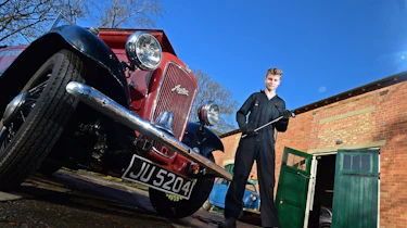 Student next to classic car