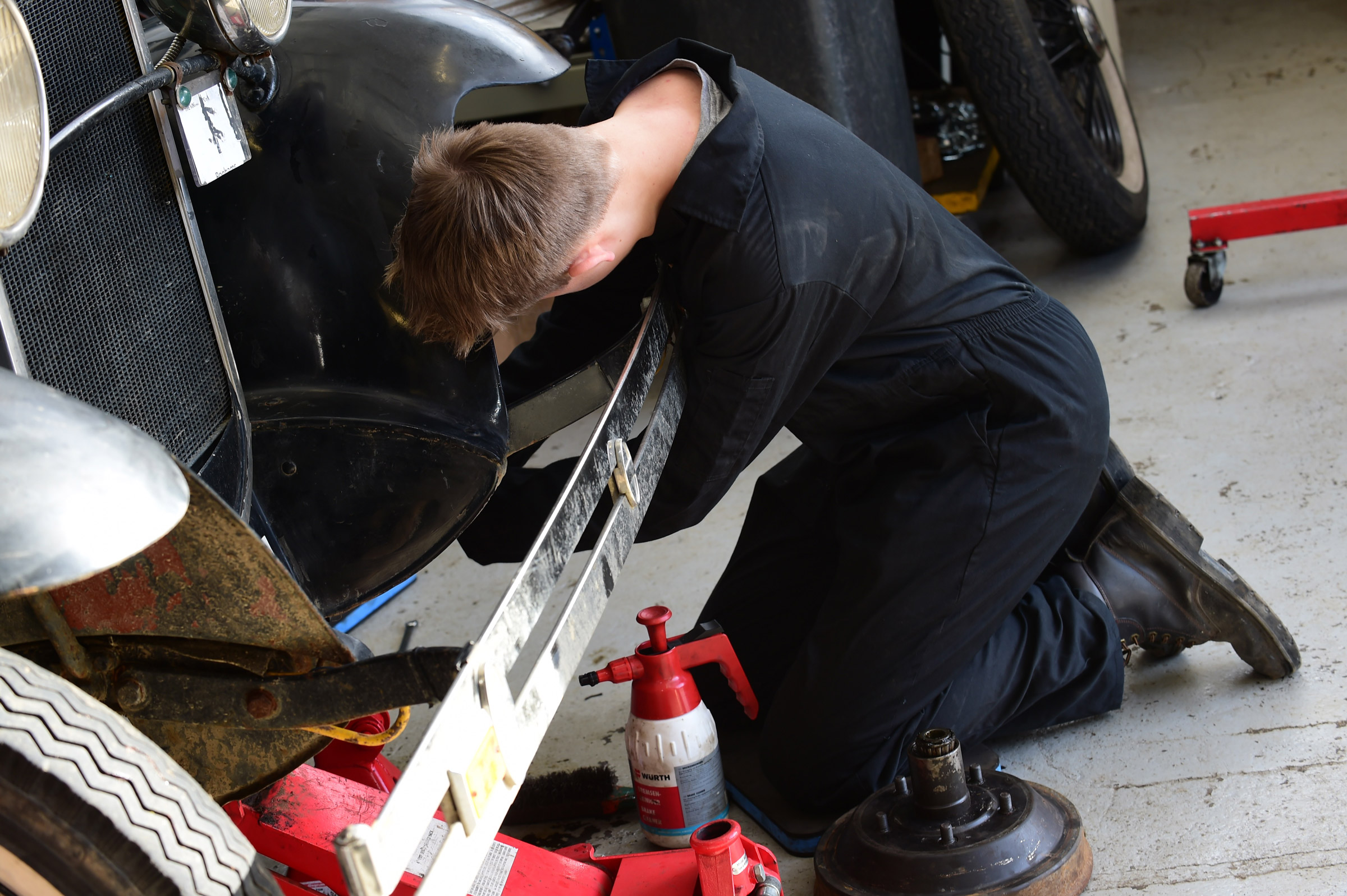 Student working on classic car