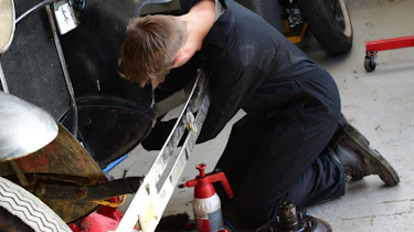 Student working on classic car