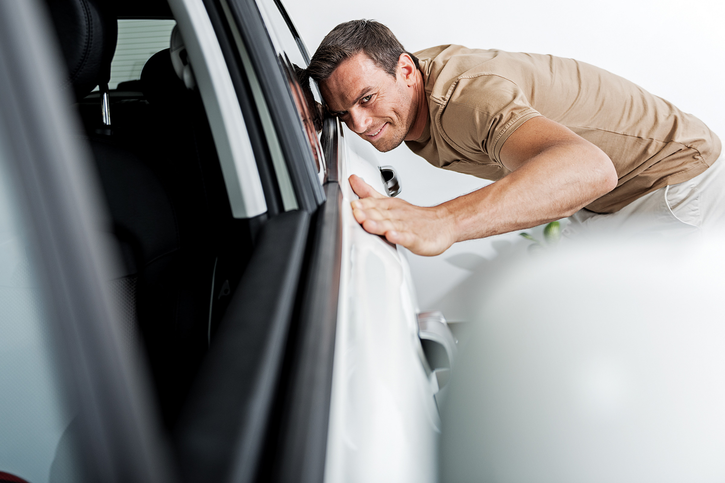 man stroking car