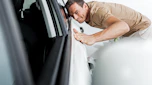 man stroking car