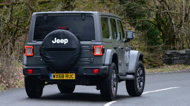 Jeep Wrangler driving rear