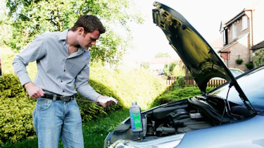 Person checking their car's oil level