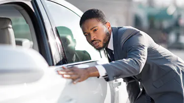Man checking car in dealership