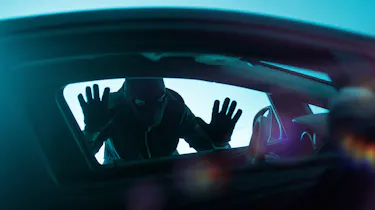 Car thief looking through a window