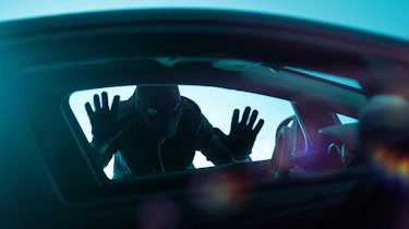 Car thief looking through a window