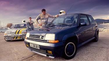 Racing drivers standing next to two Renault 5 GTs
