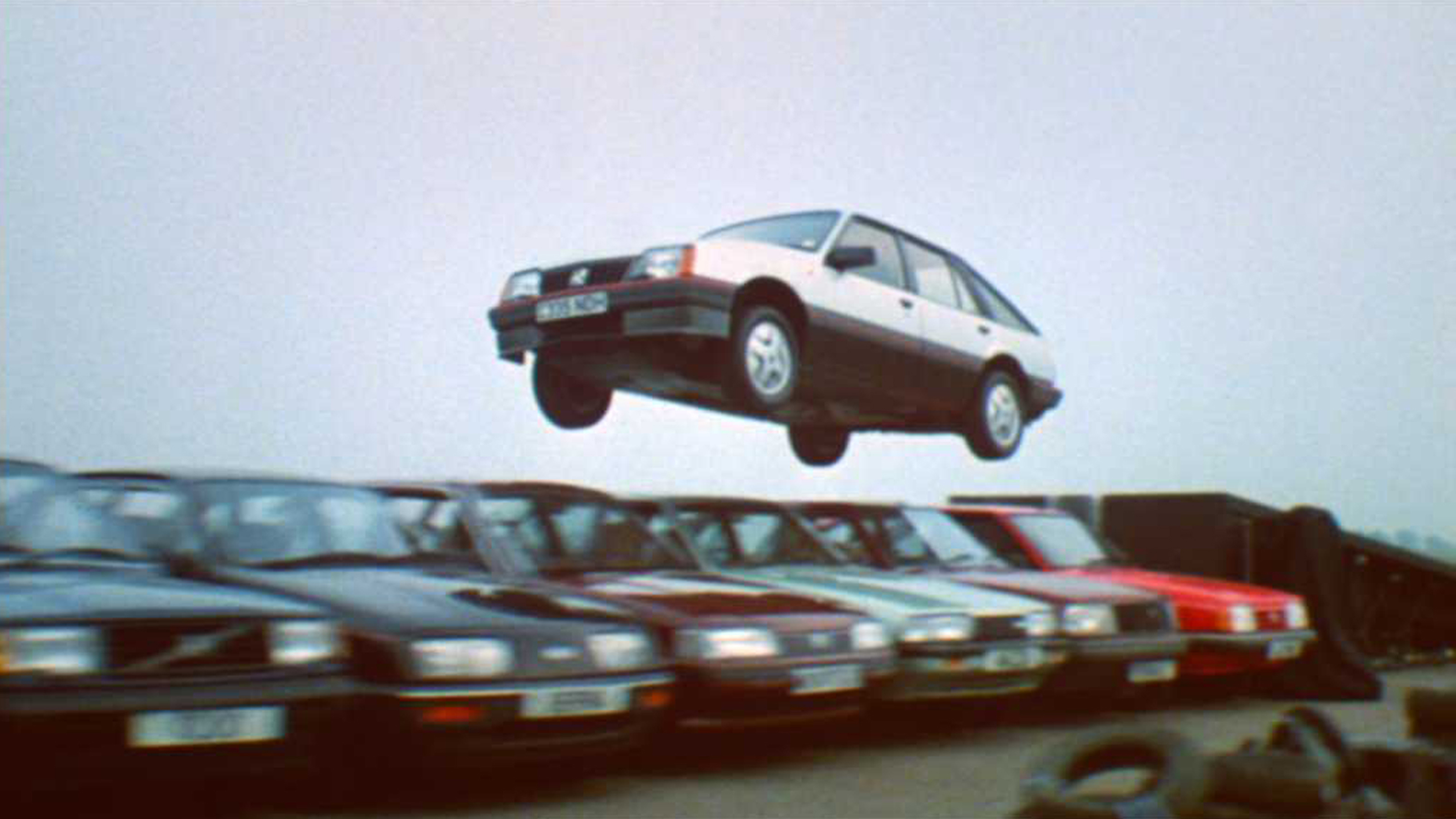 Vauxhall Cavalier (Mk2) jumping over a number of other cars