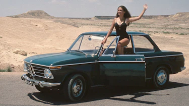 Model posing with BMW 02 Series