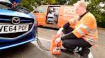RAC breakdown mechanic charging a battery