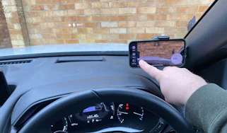 Mobile phone in windscreen cradle with dashcam app setup