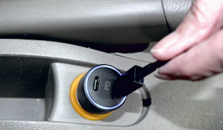 USB charger being plugged into 12v socket
