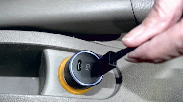 USB charger being plugged into 12v socket