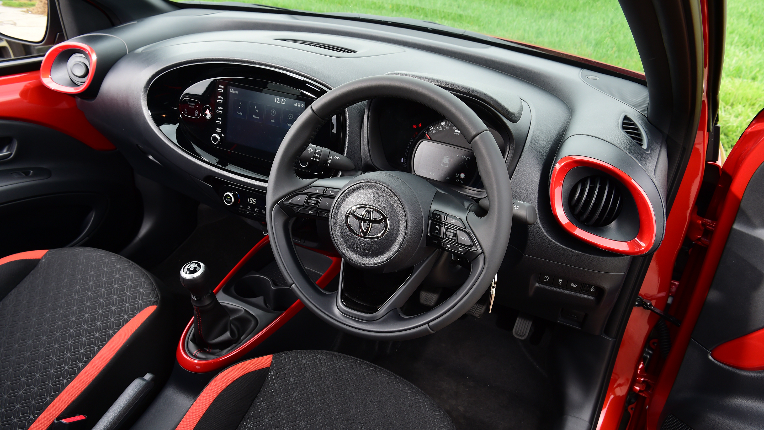 Toyota Aygo X vs Hyundai i10 vs Fiat 500 group test - Toyota Aygo X interior from driver's door