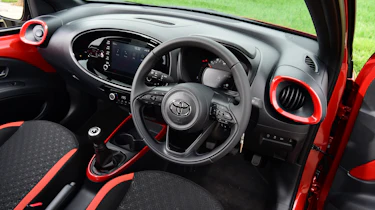 Toyota Aygo X vs Hyundai i10 vs Fiat 500 group test - Toyota Aygo X interior from driver's door