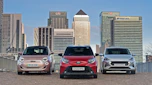 Toyota Aygo X vs Hyundai i10 vs Fiat 500 group test - three cars in front of London city skyline