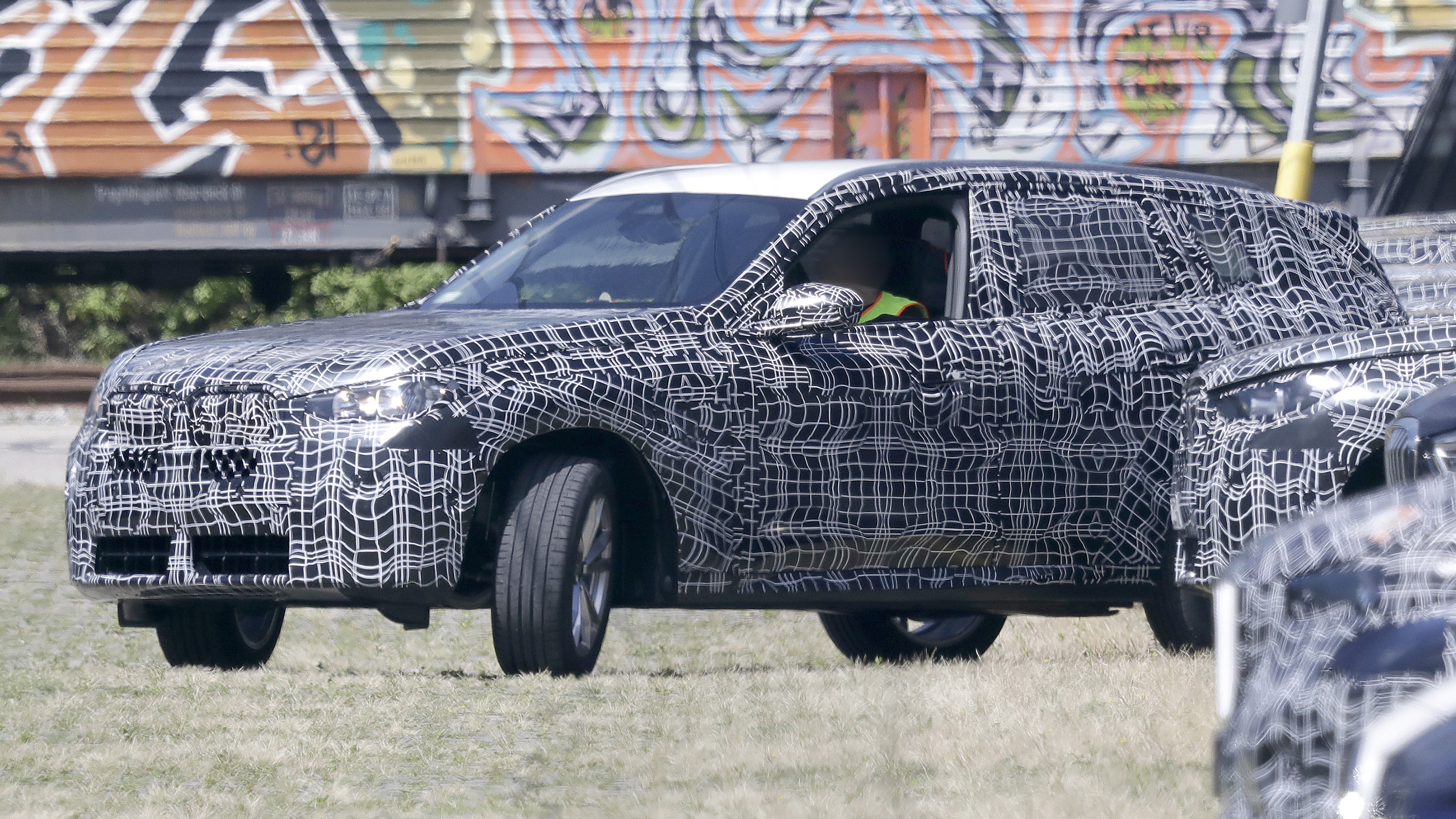 2024 BMW X3 spyshot - side (reversing into bay)