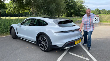 Porsche Taycan 4S Cross Turismo - John McIlroy holding a moneybag
