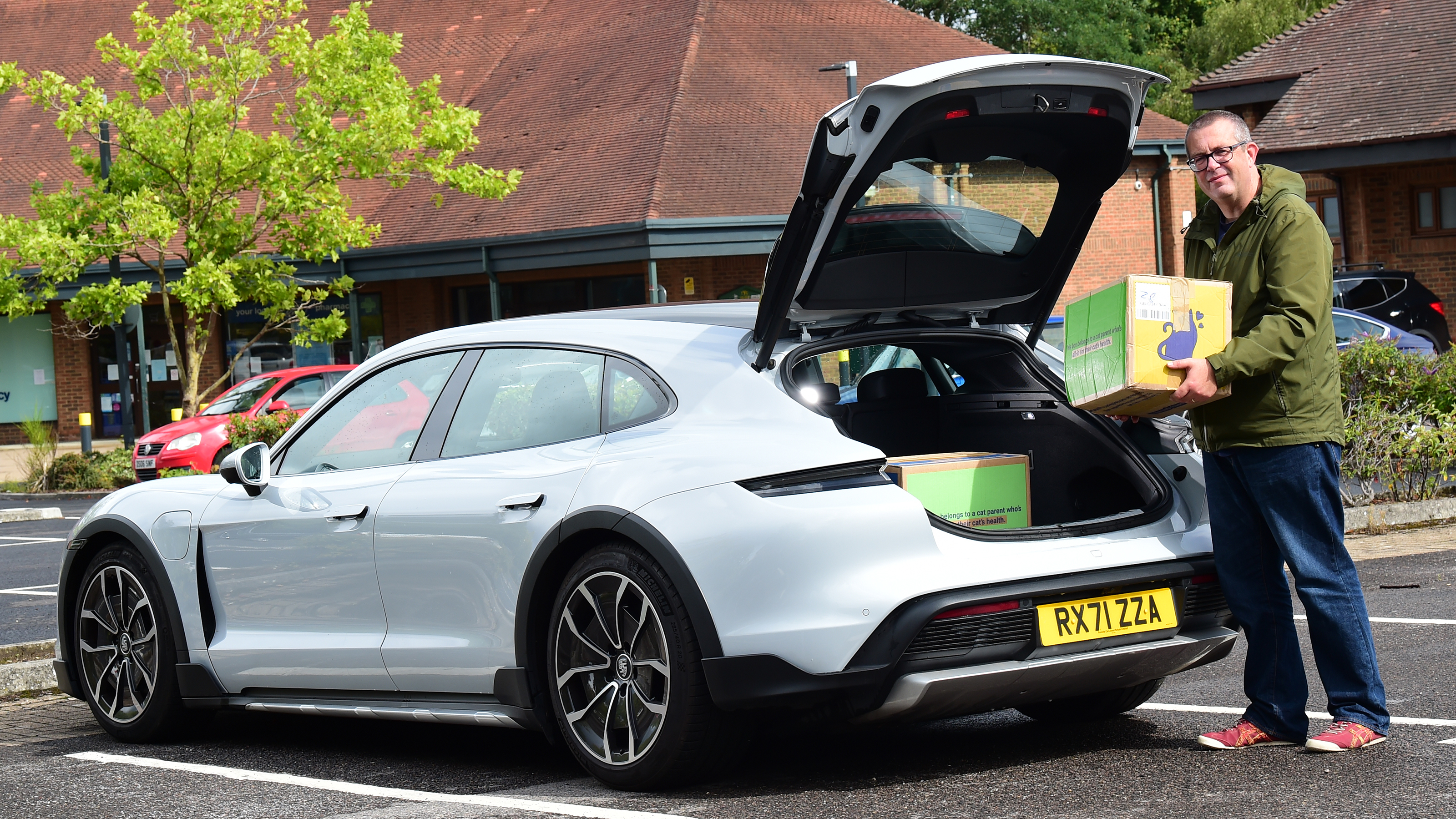 Porsche Taycan Cross Turismo long-termer - John McIlroy loading boxes into boot