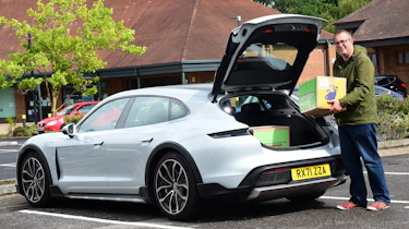 Porsche Taycan Cross Turismo long-termer - John McIlroy loading boxes into boot