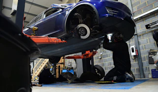 Electric car servicing car on ramp