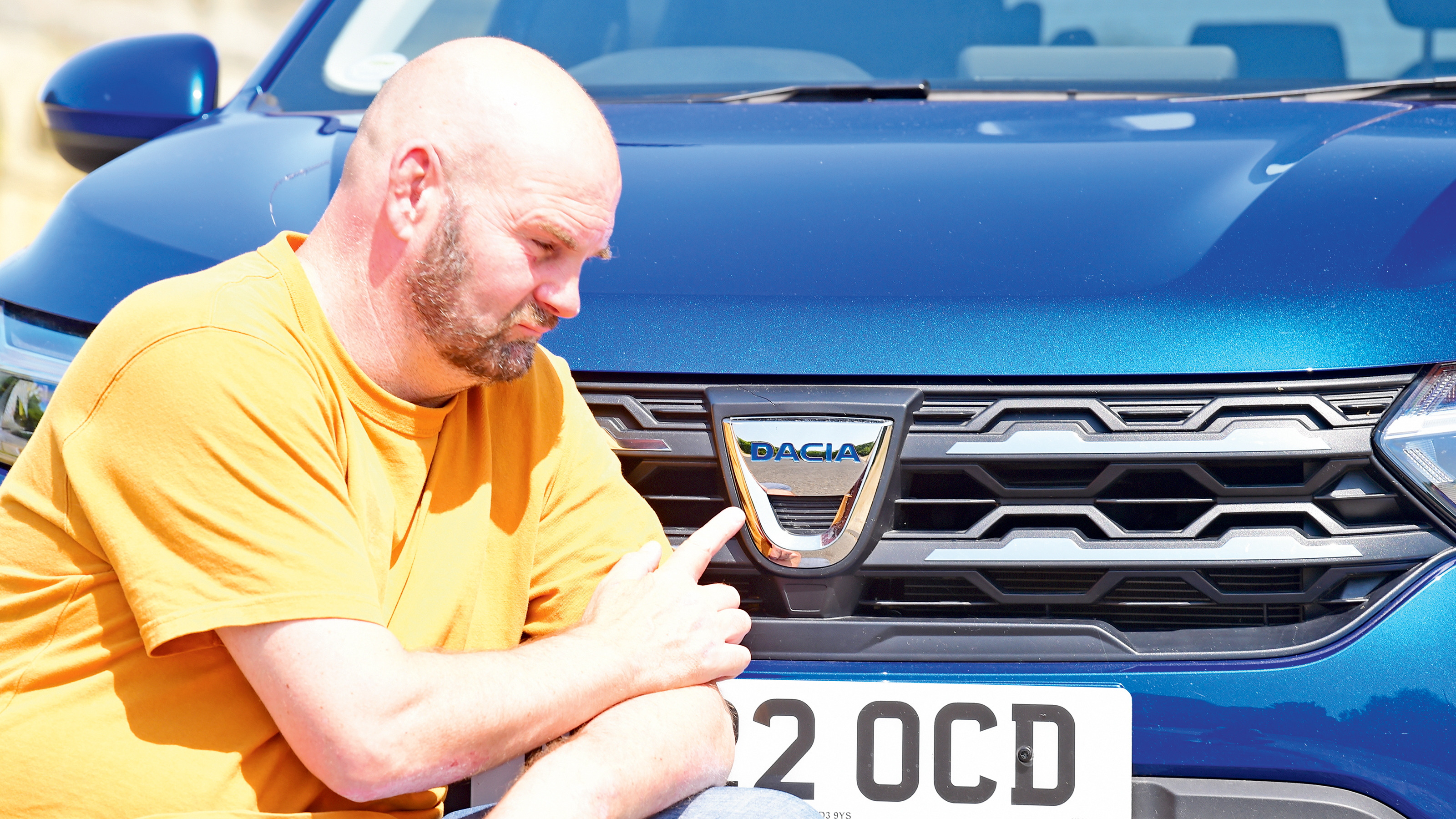 Dacia Jogger long termer - pointing at Dacia badge