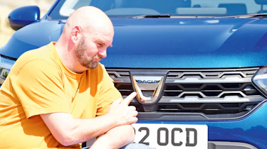 Dacia Jogger long termer - pointing at Dacia badge