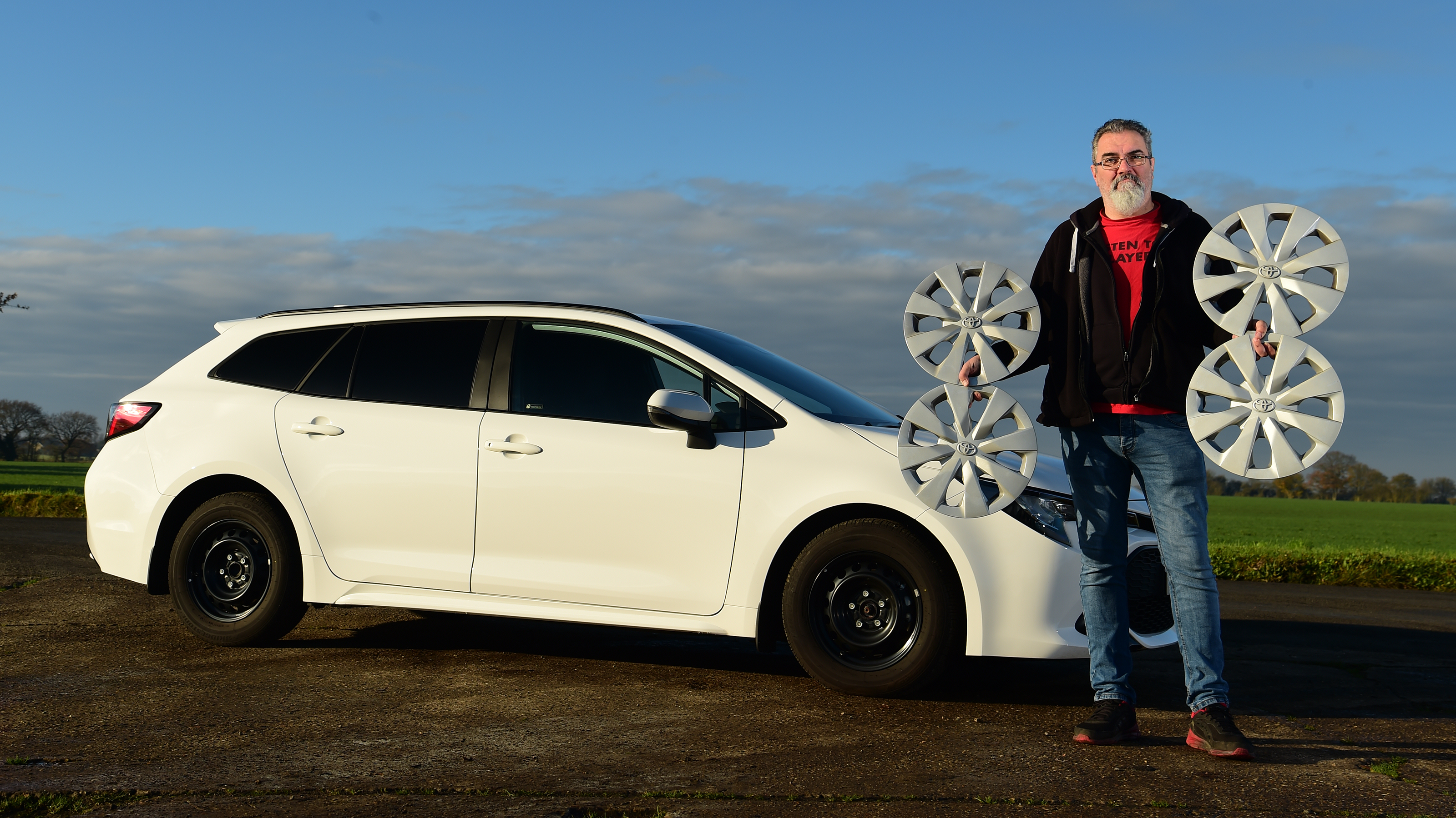 Dean Gibson holding wheel trims