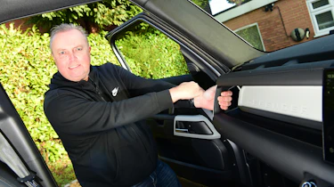 Land Rover Defender long-termer - Steve Fowler holding on to dashboard handle