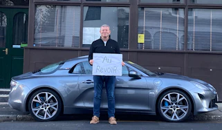 Steve Sutcliffe holding 'au revoir' sign
