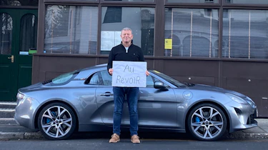 Steve Sutcliffe holding 'au revoir' sign