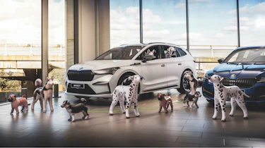 Skoda Enyaq iV surrounded by inflatable dogs