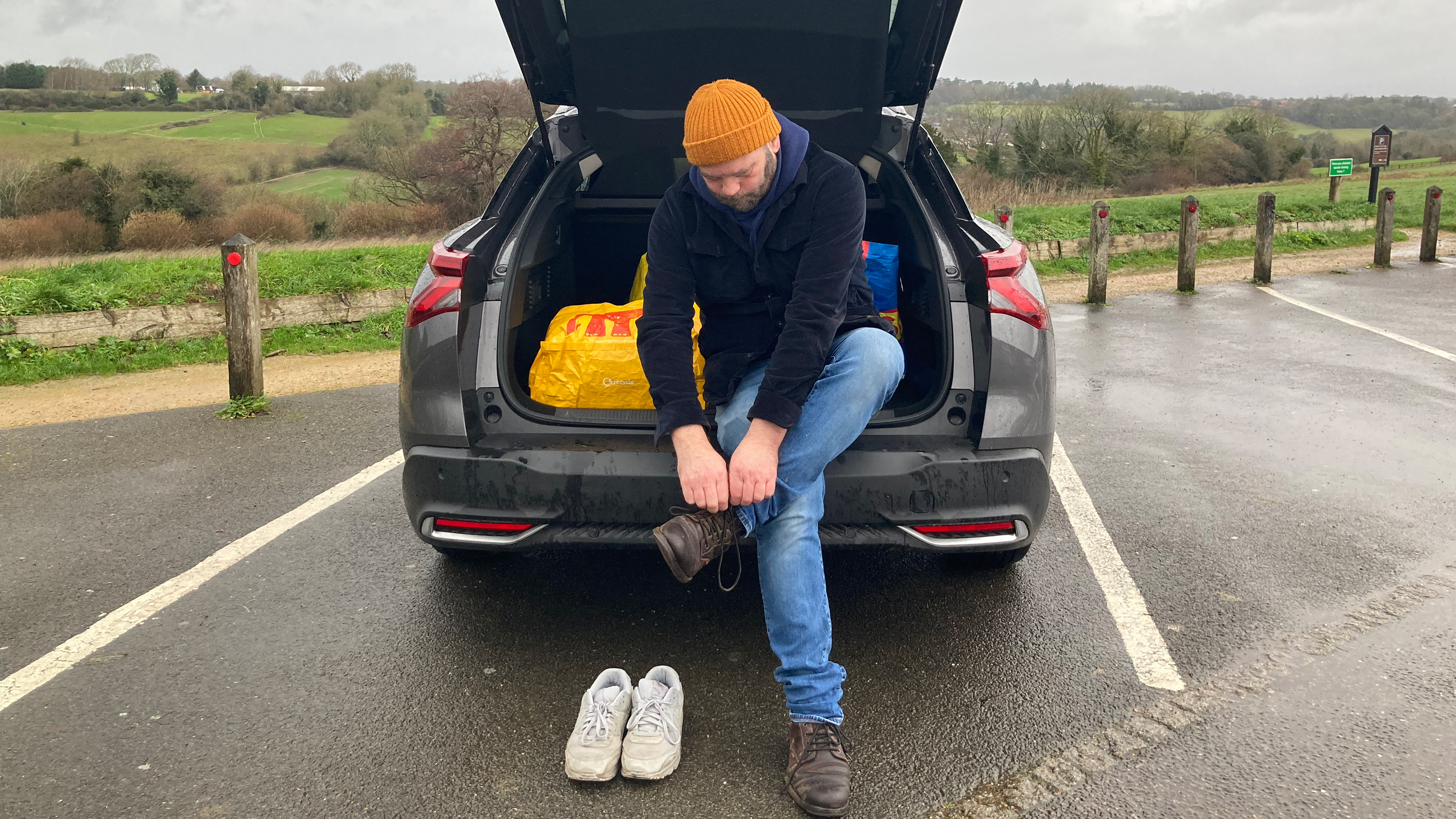 Citroen C5 X Shine long-termer - Darren Wilson fastening shoelace while sitting in boot