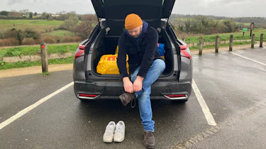 Citroen C5 X Shine long-termer - Darren Wilson fastening shoelace while sitting in boot
