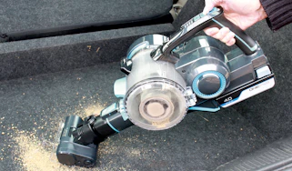Cordless vacuum cleaner cleaning up dirt