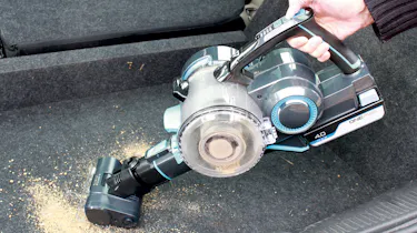 Cordless vacuum cleaner cleaning up dirt