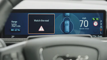 Ford Mustang Mach-e dashboard screen displaying "Watch the road" message